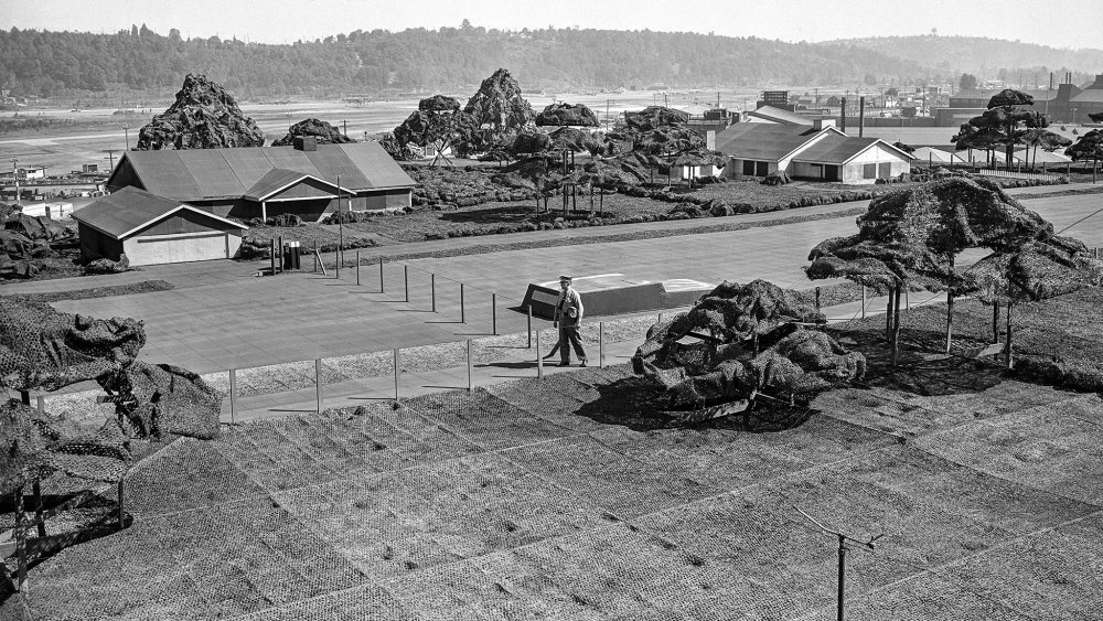 What kind of facility on the U.S. West Coast was camouflaged during World War II by building a fake civilian neighborhood over it?