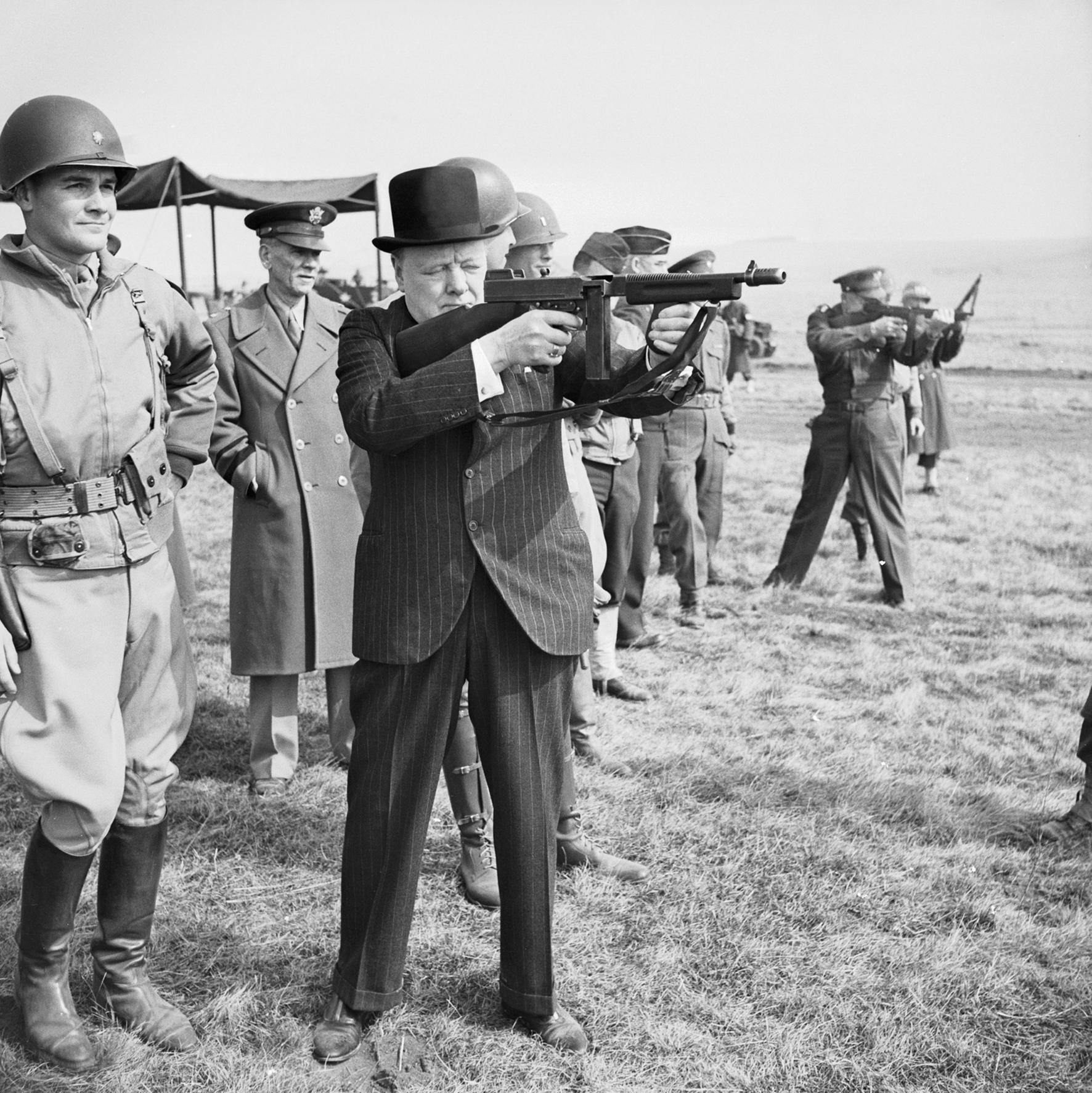 Can you identify the submachine gun held by British Prime Minister Winston Churchill?