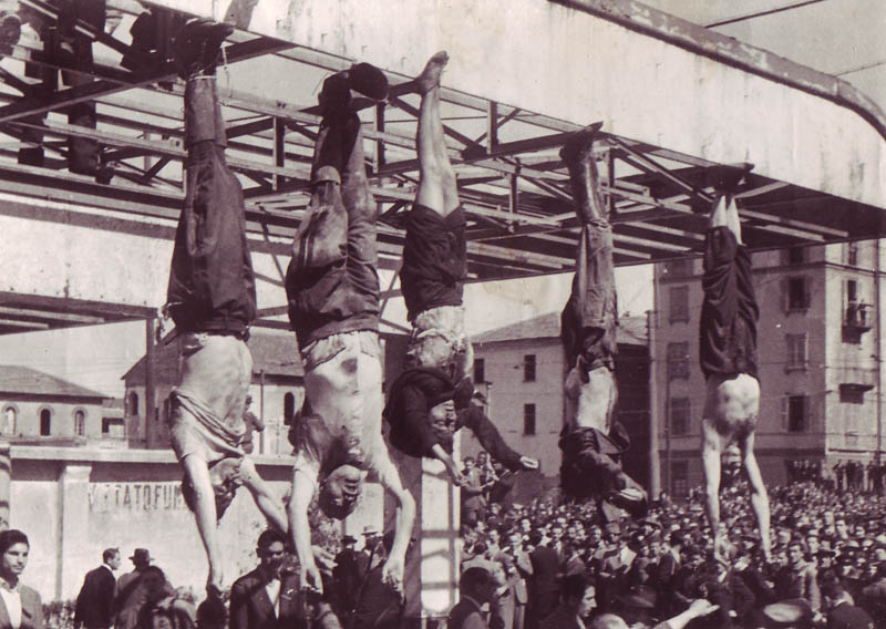 After Italian Fascist leader Benito Mussolini was killed by partisans, his body was hung upside down on public display. At what sort of venue was he displayed at?